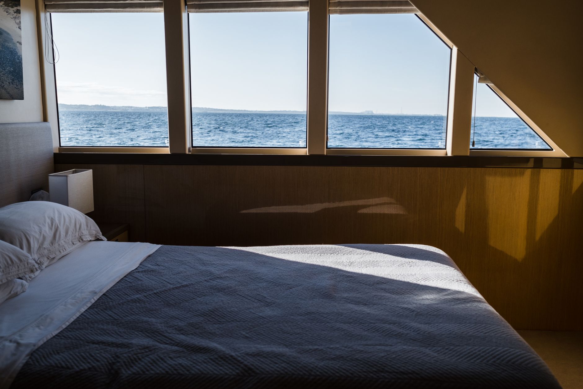 Bedroom with large windows looking out to the ocean